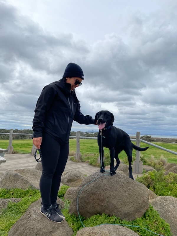 Diona standing quietly with Murphy on an overcast boardwalk