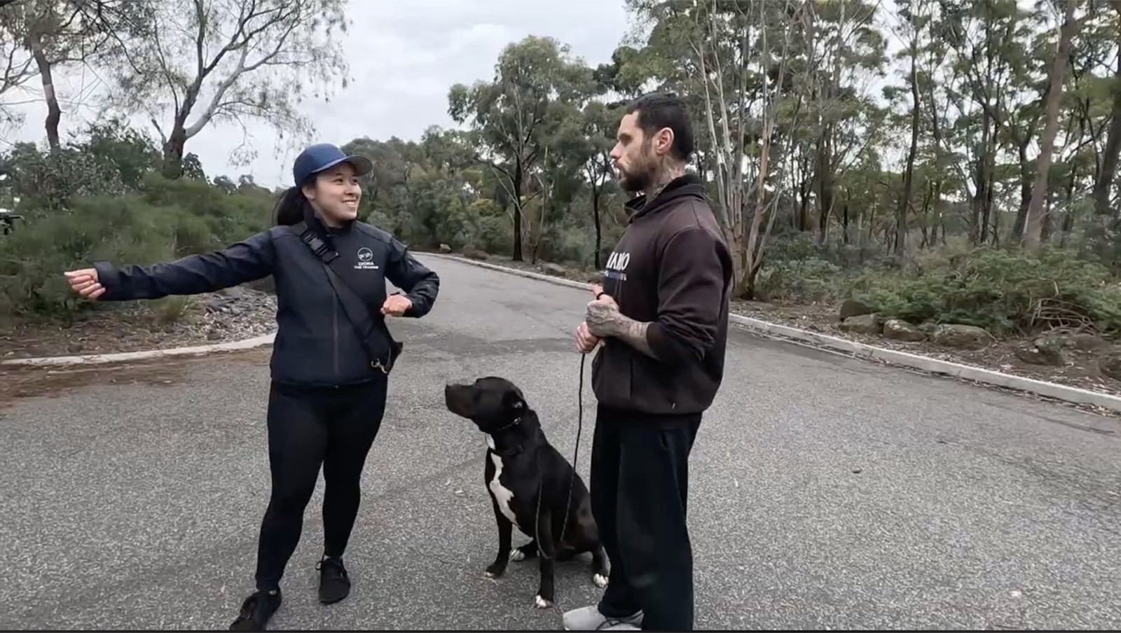 Diona coaching an owner while his dog sits calmly between them