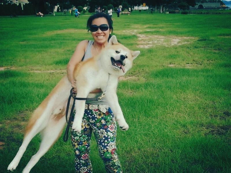 Diona as a young woman holding Pigson, the family Akita the methodology is named for